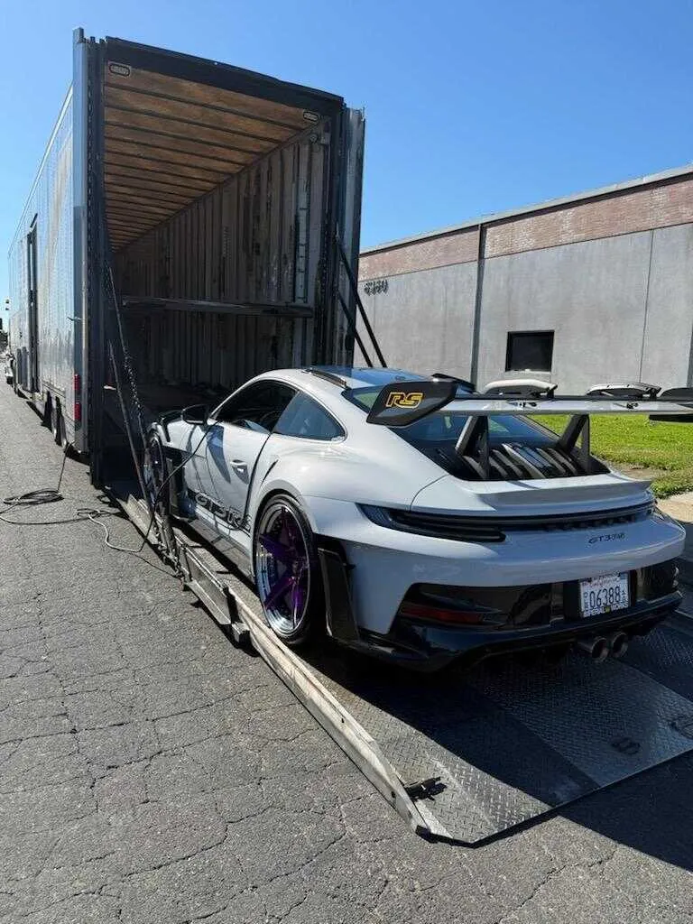 White Porsche 911 GT3 RS being loaded for secure supercar shipping from Bay Area California to Las Vegas Nevada for SEMA show