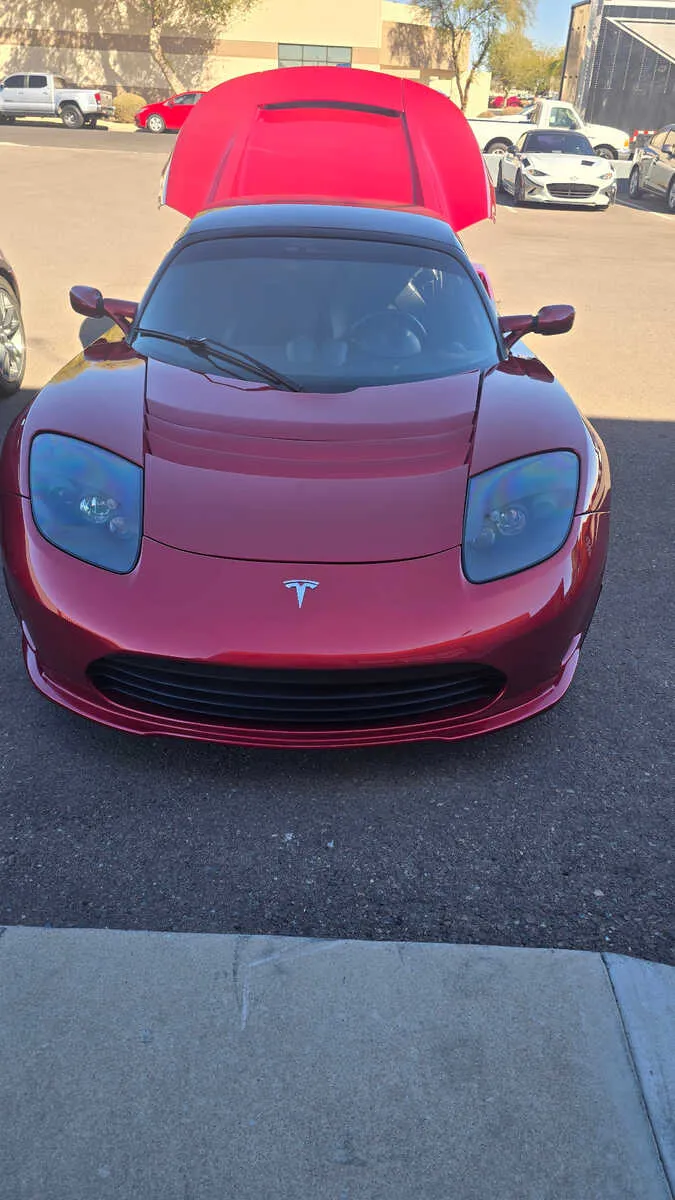 Maroon Tesla Roadster with scissor doors loaded for professional exotic EV shipping from Scottsdale Arizona to Miami Florida
