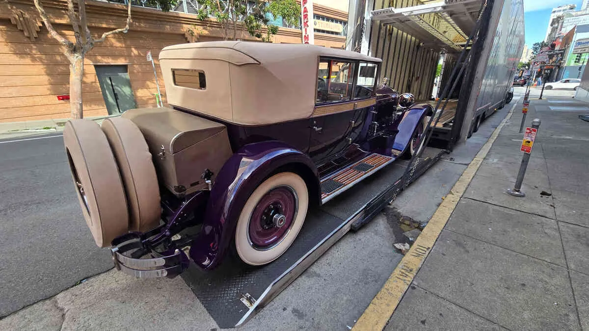 Rare vintage purple classic car from San Francisco museum safely loaded for long-distance enclosed transport to Miami Florida